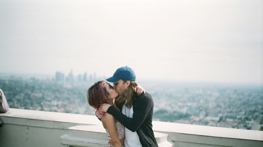 A woman and her companion sharing an outdoor travel moment.